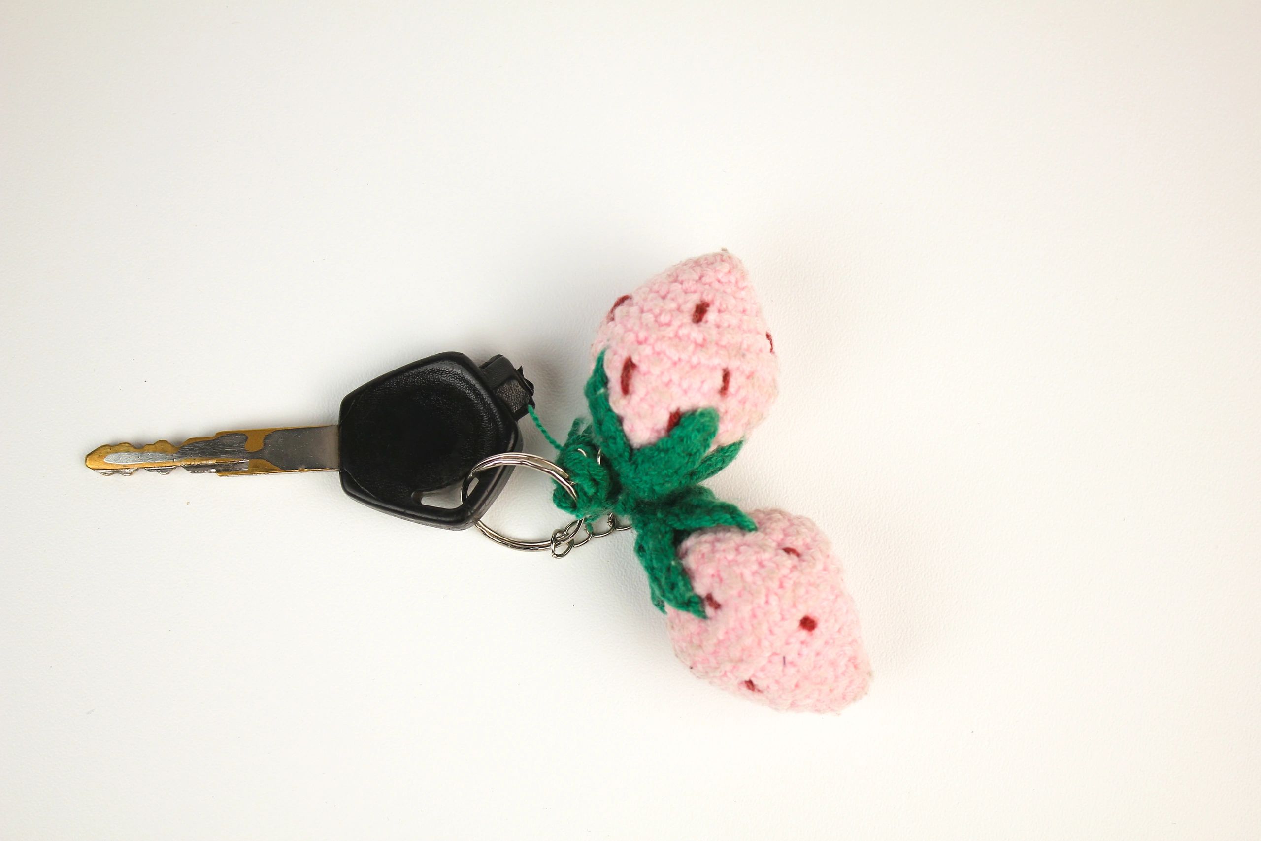 Handmade crochet keychain attached to a key