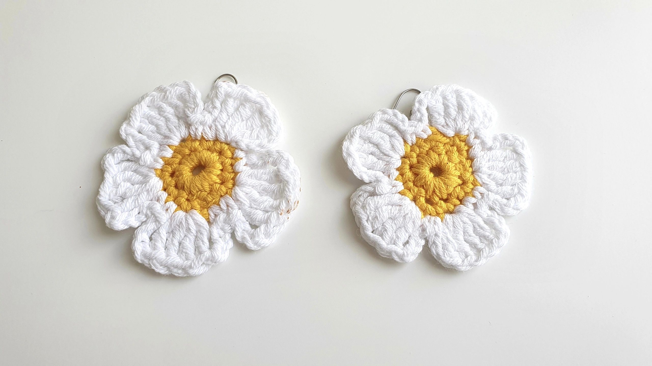 Handmade daisy-shaped crochet earrings