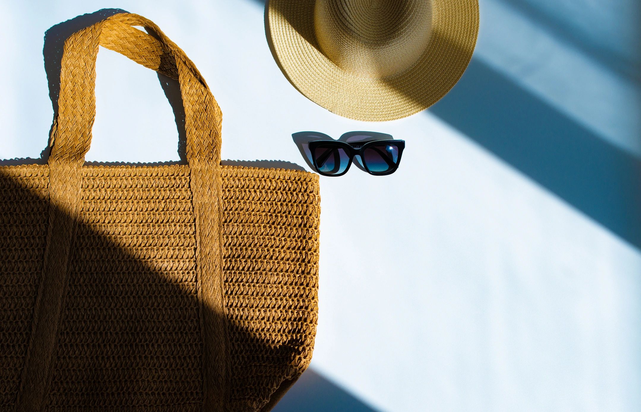 Summer accessories flat lay with woven textures